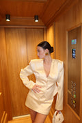 Person in a white robe lying inside a wooden sauna