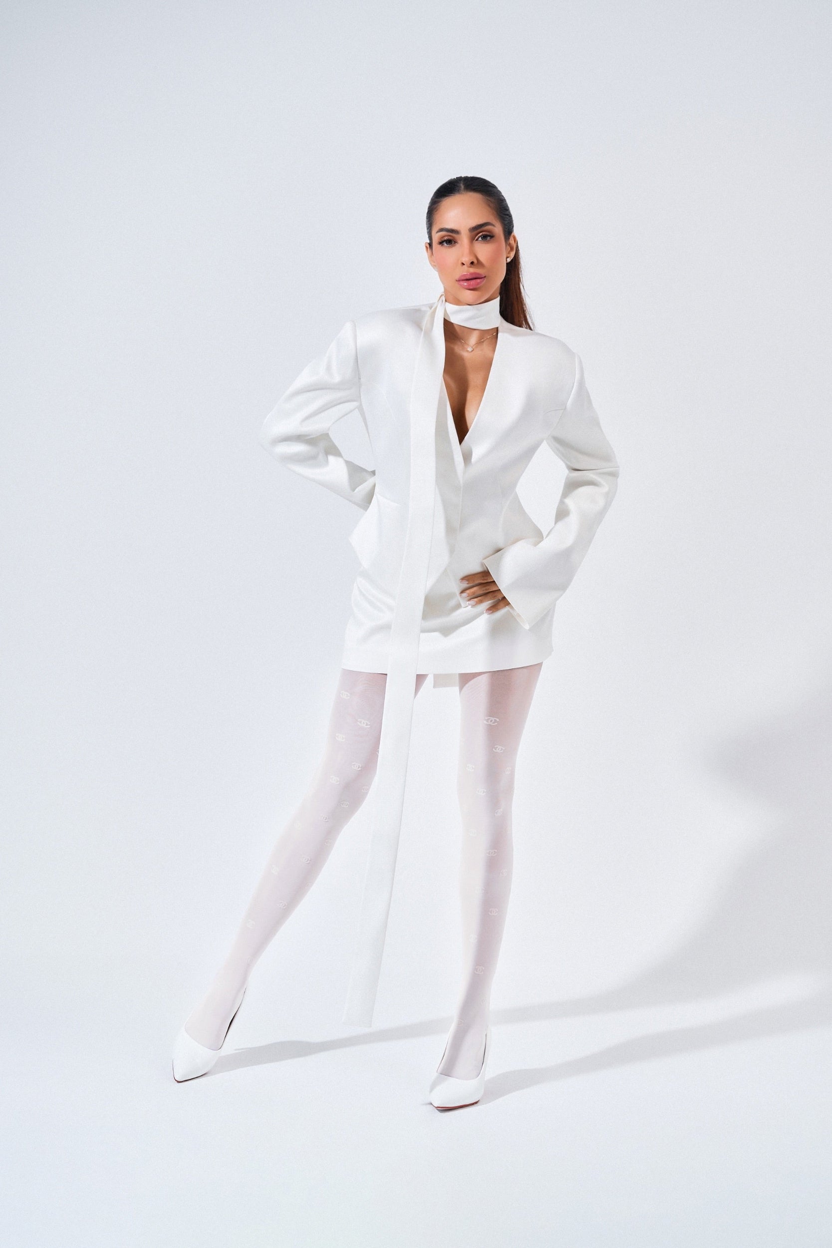 Person wearing a white outfit on a plain background